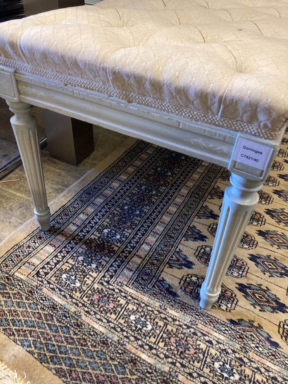 A Regency style cream painted dressing stool, with a buttoned seat, width 122cm, depth 45cm, height 44cm